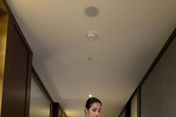 Malaika Arora is in a champagne Tarun Tahiliani concept sari that is elevated with Swarovski crystals